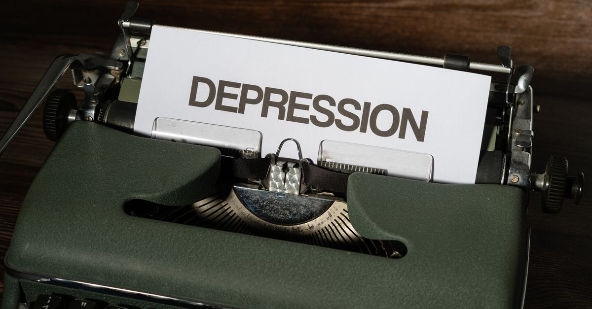 A vintage typewriter with the word 'Depression' typed on paper, conveying a mental health theme.