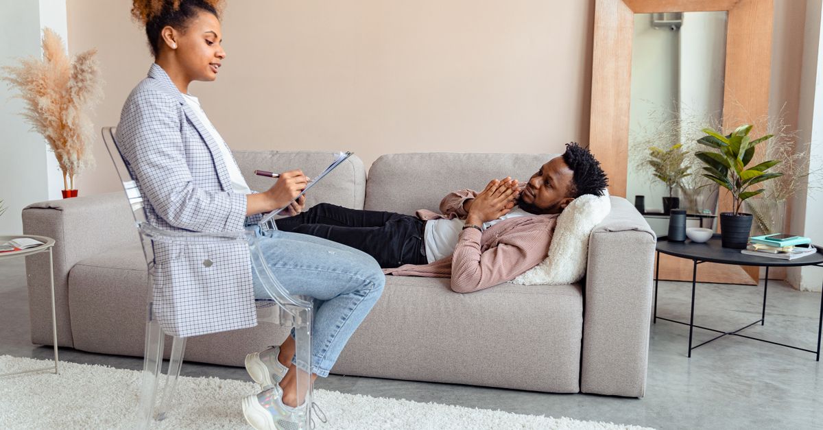 Patient and therapist in a modern therapy session indoors.